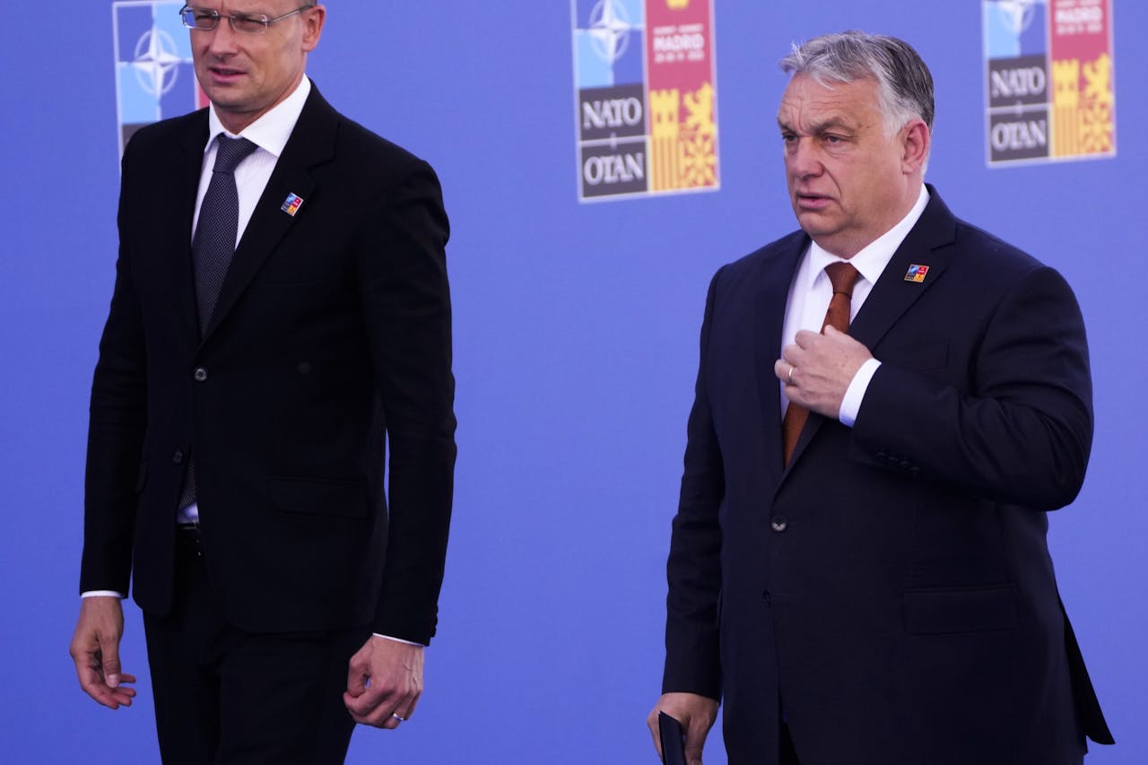 De Hongaarse premier Viktor Orbán (r) en zijn minister van buitenlandse zaken Péter Szijjártó bij de Navo-top vorig jaar juni in Madrid. Boedapest maakt geen haast bij het stemmen over de toetreding van Zweden en Finland tot het militaire bondgenootschap.