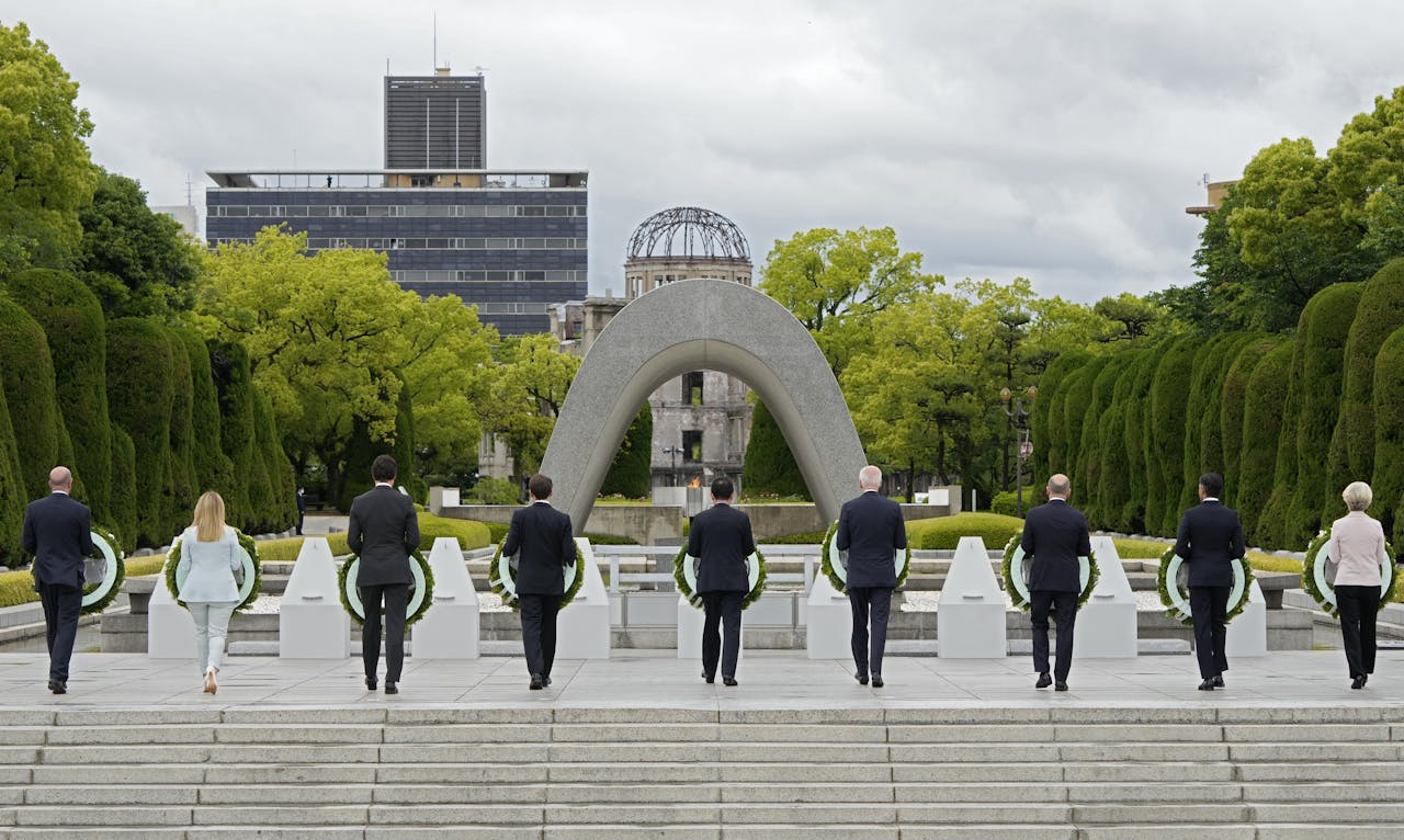Deelnemers aan de G7-top in Hiroshima leggen ieder een krans bij het monument ter nagedachtenis aan de slachtoffers van de atoombom. In het midden de Japanse premier en gastheer Fumio Kishida.