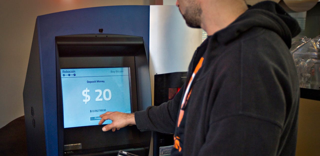 Een klant gebruikt de eerste 'bitcoin-pinautomaat' in een cafe in Vancouver. Men kan hier bitcoins opnemen in de vorm van Canadese dollars of cash storten om meer bitcoins te kunnen kopen.