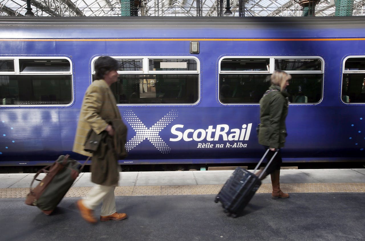 Passagiers bij een trein van ScotRail in Glasgow. foto: HH