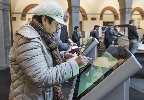 In de Stadswinkel van de gemeente Rotterdam geven burgers via een digitaal scherm aan voor welke dienst zij komen.