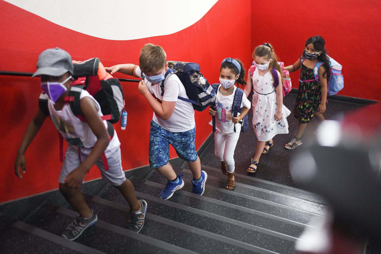 Duitse scholieren in Dortmund gaan gebonden aan strenge coronaregels de trap op richting klaslokaal.