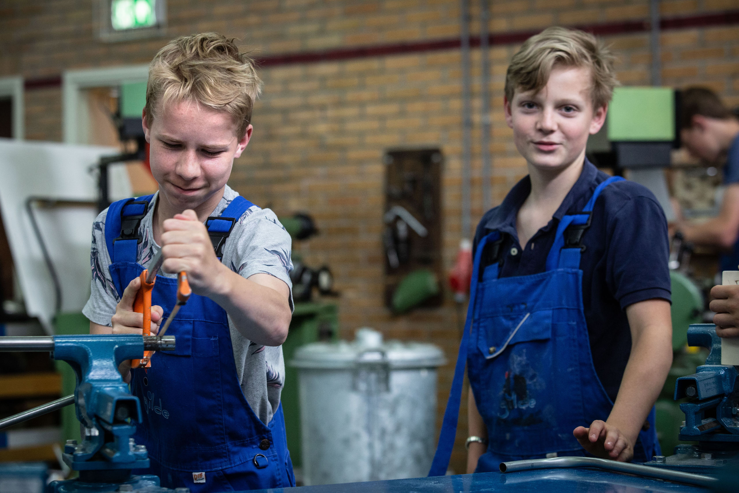 Jongeren van de techniekhavo krijgen tien uur in de week techniek. Hier zijn ze aan het werk met een bankschroef.